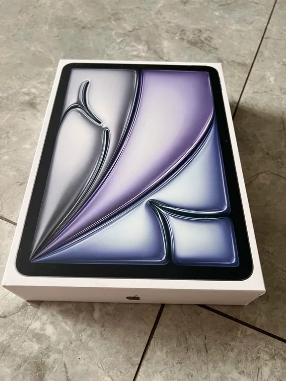 Retail packaging box for an iPad Air showing a colorful screen wallpaper
