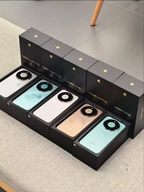 Row of black retail boxes with unboxed smartphones displayed neatly on a grey surface