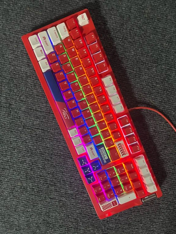 Red-framed gaming keyboard featuring illuminated RGB keys and arrow key accents
