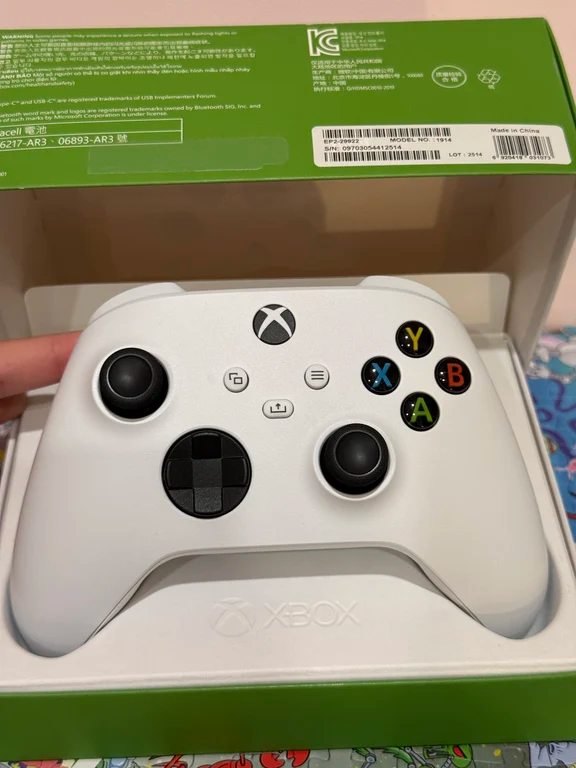 Robot White Xbox Series wireless controller sitting inside an open retail box