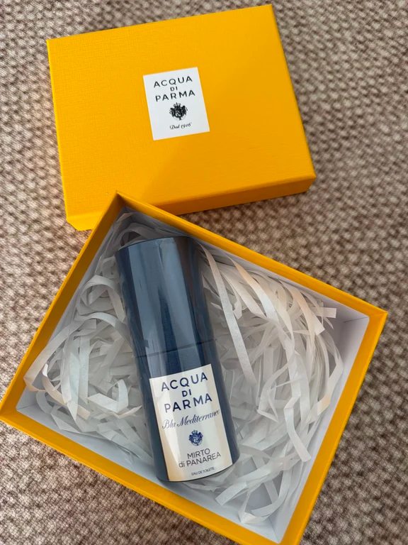 Acqua di Parma Mirto di Panarea travel spray in an open yellow brand box