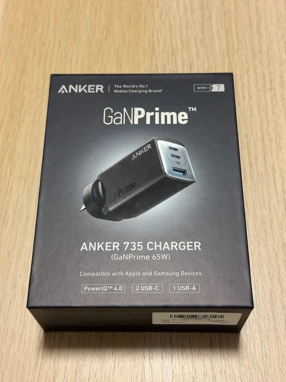 Retail box of the Anker 735 GaNPrime 65W wall charger on a light wood surface