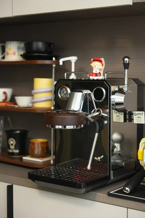 Black semi-automatic espresso machine with wooden group head trim and steam lever