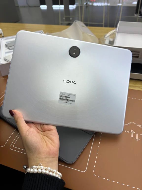 Silver metallic OPPO tablet showing the back panel with centered camera and branding