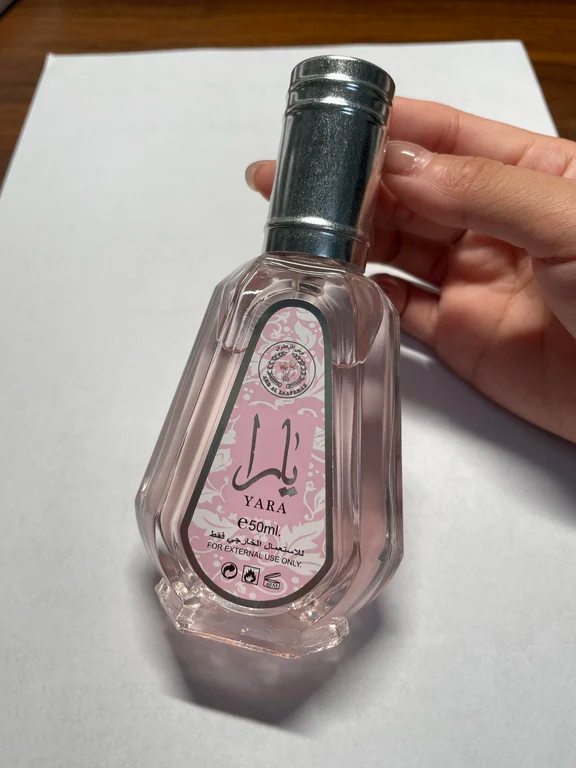 Clear glass 50ml spray bottle labeled Yara with a pink floral design and silver cap.