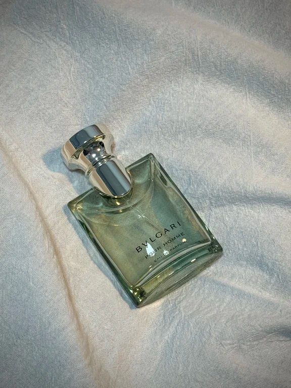 A bottle of Bvlgari Pour Homme Eau de Parfum resting on light textured fabric.