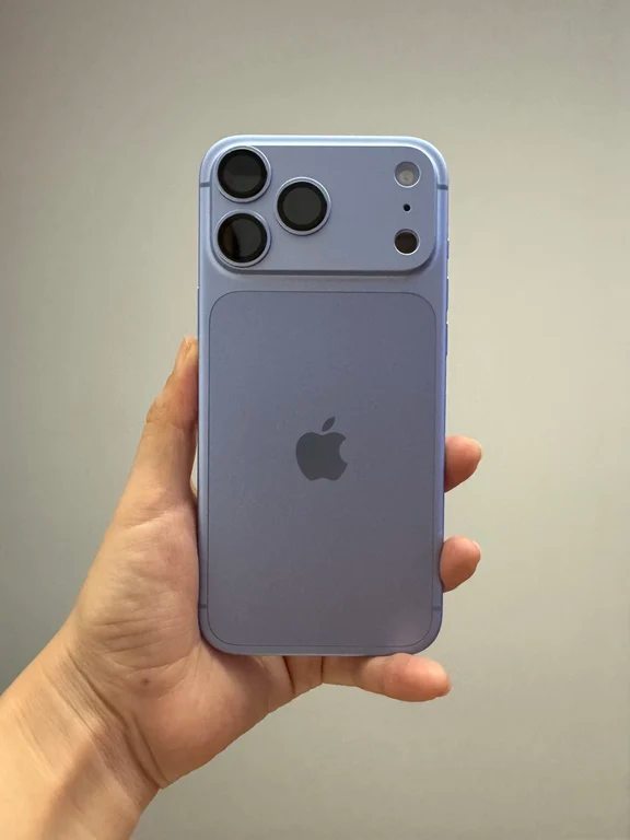 Hand holding a light blue concept smartphone with an extended horizontal camera island and matte back